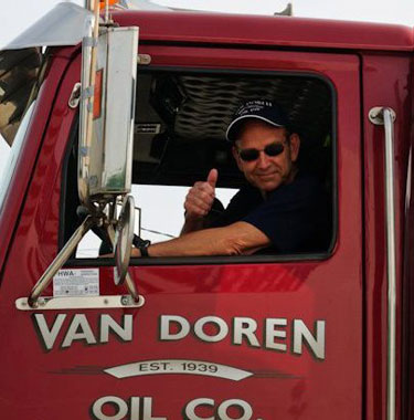 Van Doren truck driver giving thumbs up from driver's window of red truck